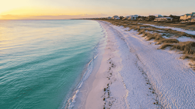 Aerial view of a white sand beach on Florida's Gulf Coast with turquoise water