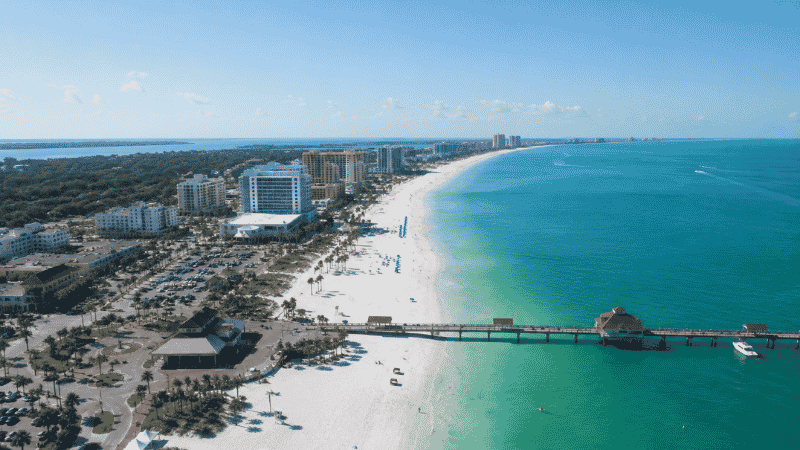 Aerial view of Clearwater Beach Florida with white sand and turquoise Gulf water near Pier 60