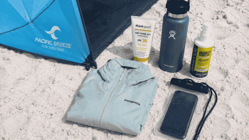 Beach packing essentials for Destin Florida including shade shelter, reef-safe sunscreen, and insulated water bottle