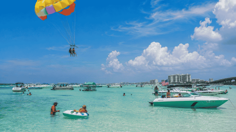 Summer activities at Destin Florida including parasailing and Crab Island boats
