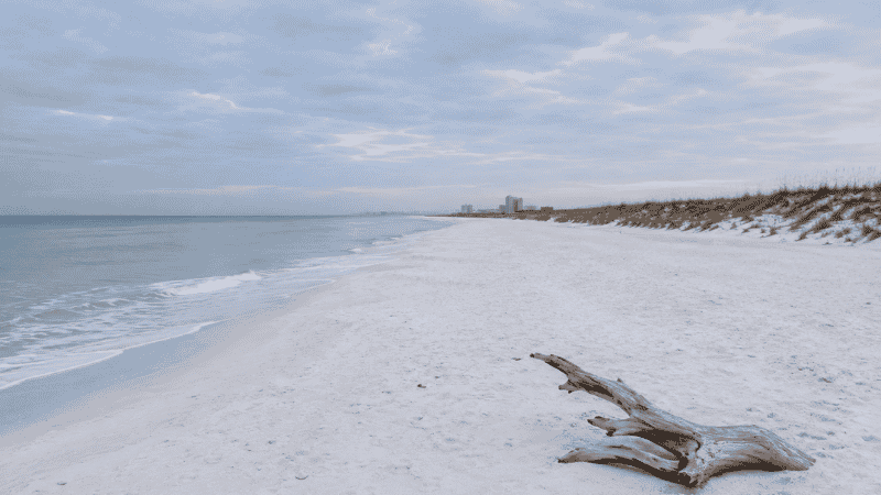 Empty Destin Florida beach in winter with calm water and soft grey sky