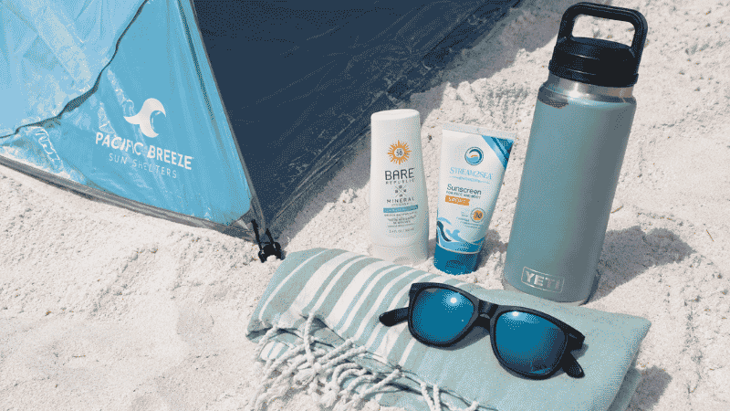 Florida beach packing essentials including sun shelter, reef-safe sunscreen, and insulated water bottle