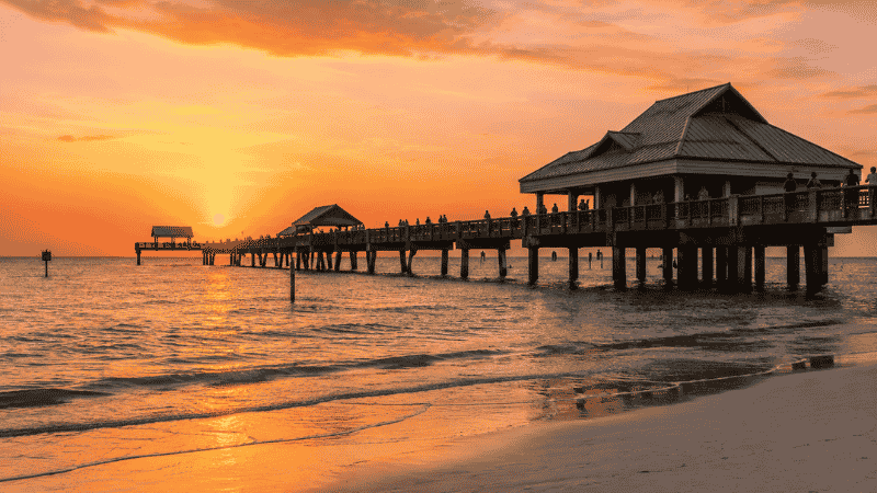 Pier 60 at Clearwater Beach Florida during golden hour sunset with calm Gulf water
