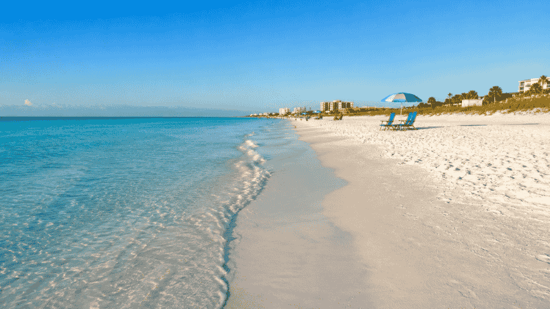 Siesta Key Beach Florida ground level view of white quartz sand and calm turquoise Gulf water