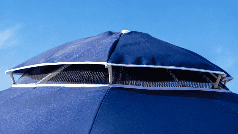 Close up of a beach umbrella vented canopy showing the wind vent at the peak for wind resistance