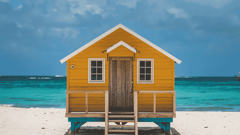 The seaside wooden house captured from San Pedro, Belize, with the backdrop of the azure Caribbean Sea and palm trees.