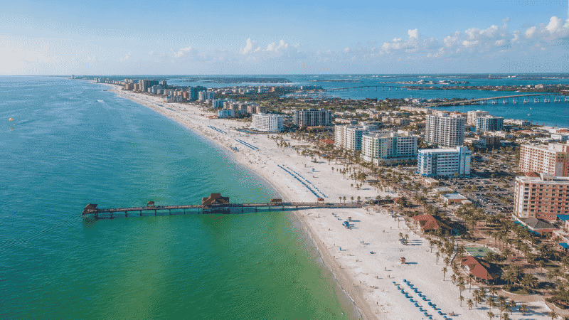 Aerial view of Clearwater Beach Florida showing three miles of white quartz sand beach and turquoise Gulf water with Pier 60