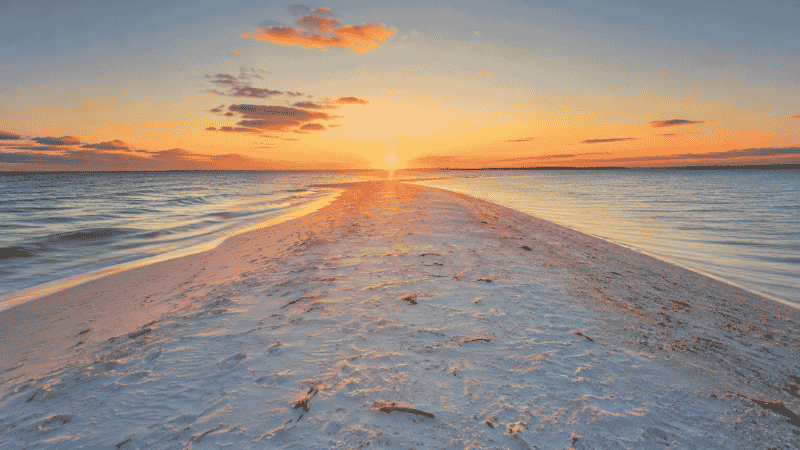 Coquina Beach at Anna Maria Island Florida with white sand Gulf water and beach pavilion facilities on a sunny day