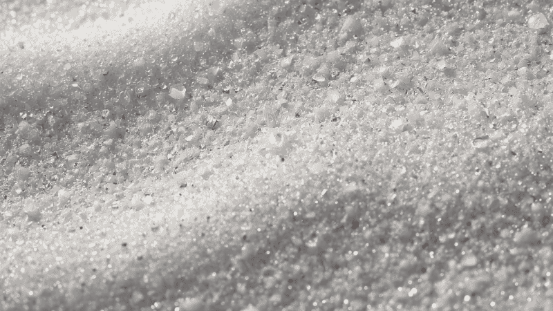 A close-up view of the Siesta Key Beach's 99% pure quartz sand, which is as fine as sugar, showcases its distinctive powder-like texture.