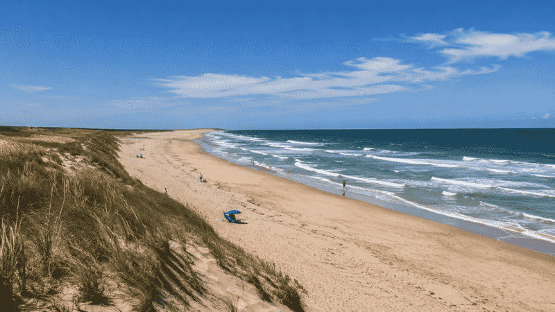 Coast Guard Beach at Cape Cod National Seashore in Eastham Massachusetts showing wide dramatic Atlantic beach with waves and sand dunes curving to the horizon